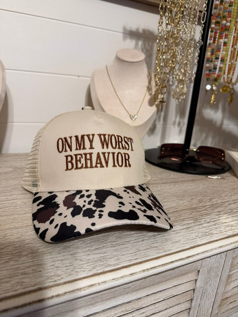 on worst behavior trucker hat with cow print