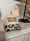 on worst behavior trucker hat with cow print
