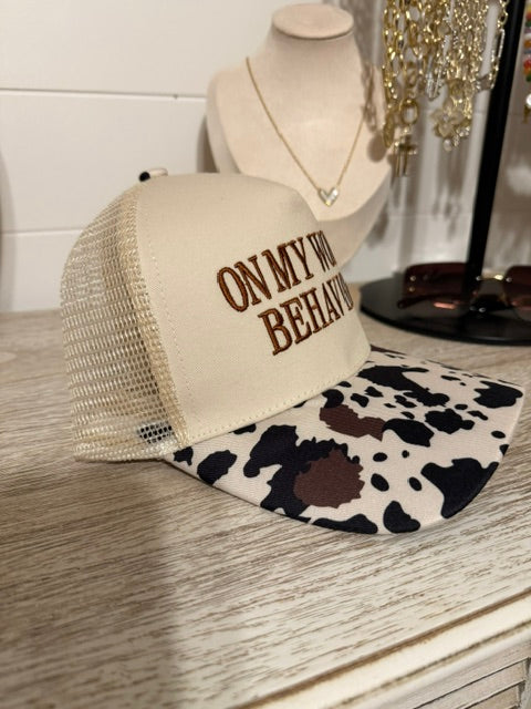 on worst behavior trucker hat with cow print